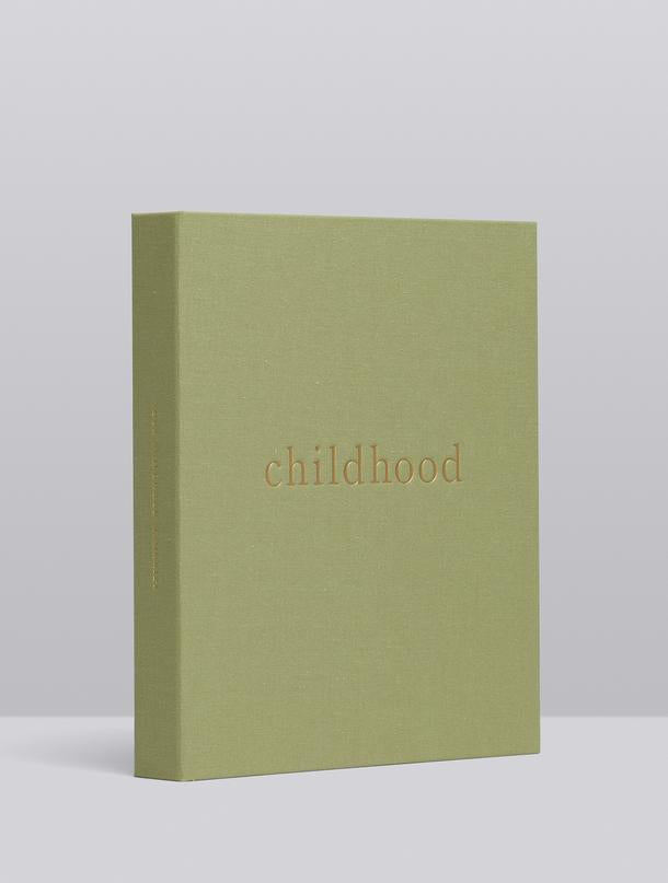 Childhood journal in sage linen at an angle, showing the linen-bound spine