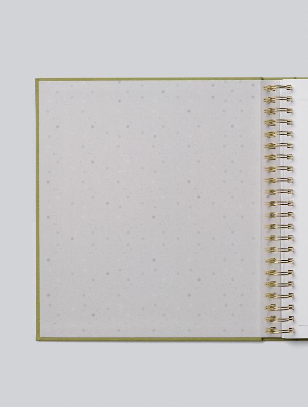 Childhood journal opened to its speckled inside cover and gold spiral binding