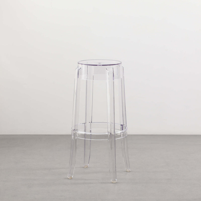 A transparent Flux Home Casper Bar Stool - 75cm on a white floor.