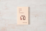 A piece of paper with the words "Come Home to Yourself" on it, reminding individuals to find solace in solitude and prioritize their relationships with design and lifestyle books as their guide, from the brand Thought Catalog, by Déjà Rae.