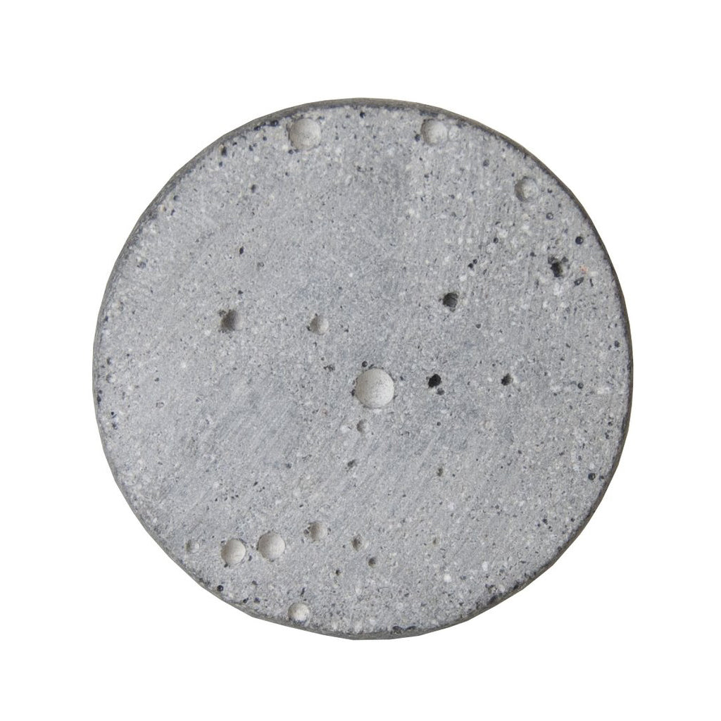 Top view of the round Zakkia concrete knob showing its pitted natural finish