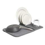An Udry Drying Mat Mini by Umbra with plates and utensils.