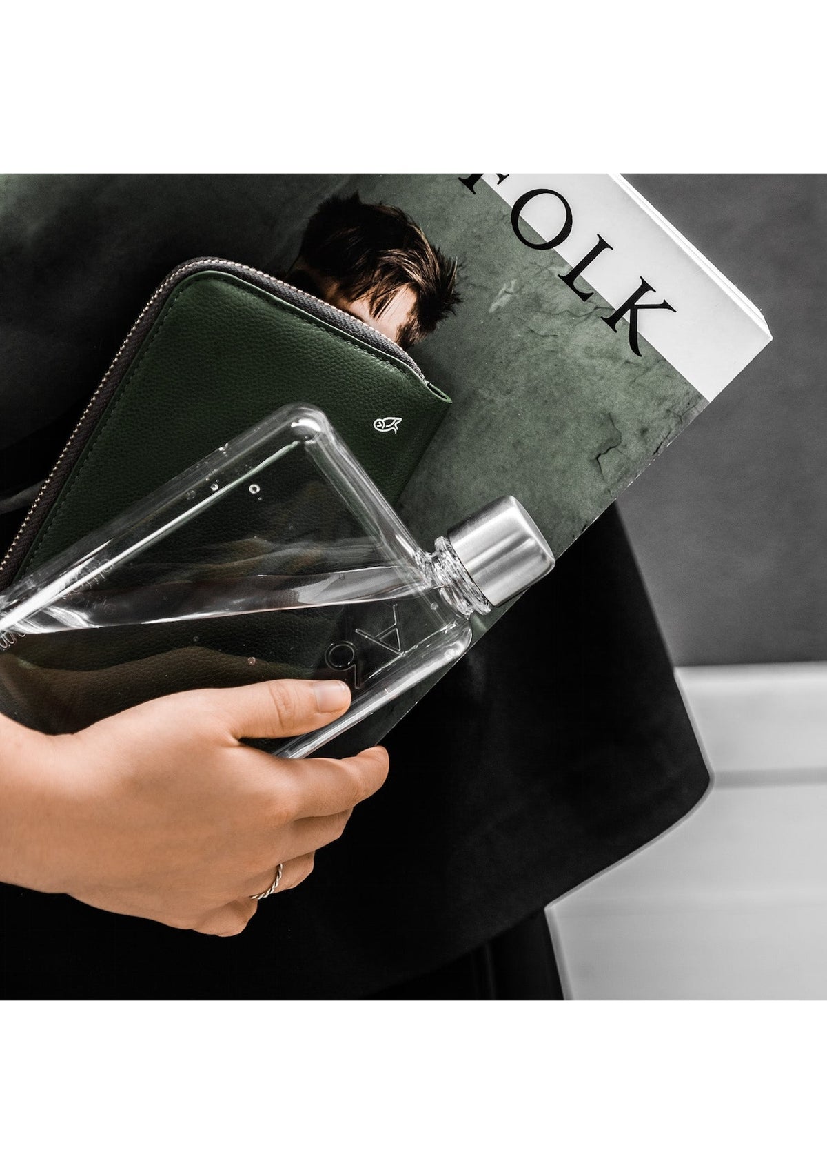A woman holding an A6 Memobottle and hydration.