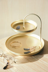 An elegant Umbra Poise Two Tier Ring Dish Brass jewelry holder that also doubles as an accessory organizer. This sleek tray is perfect for holding a pair of glasses and a pair of earrings in style. With its stunning design and functionality