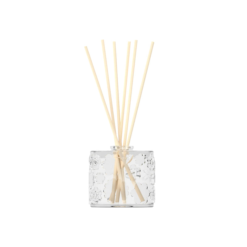A FLWR Diffuser - Purple Reign by The Aromatherapy Co with wooden sticks in it.