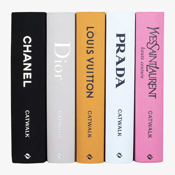 A set of four Catwalk: The Complete Fashion Collections - Various Options books with Chanel logos on them.