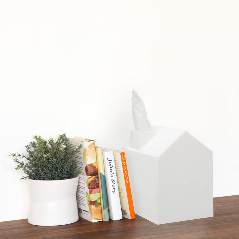 An Umbra Casa Tissue Box Cover White sits on a shelf.