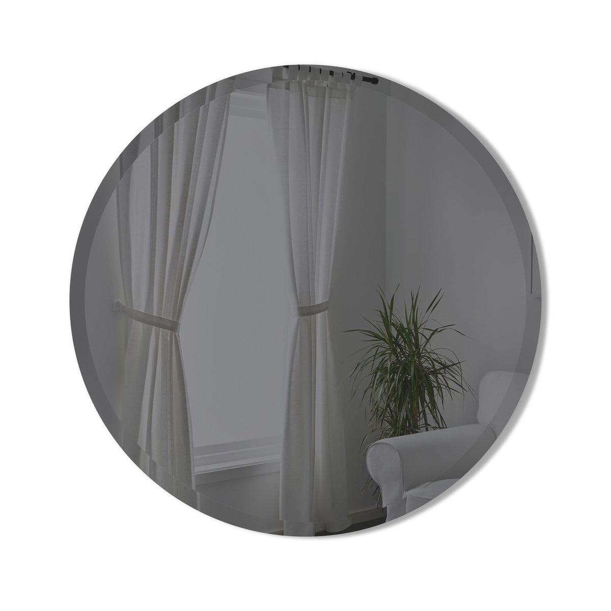 Umbra Bevy round mirror in smoke glass reflecting curtains and a plant