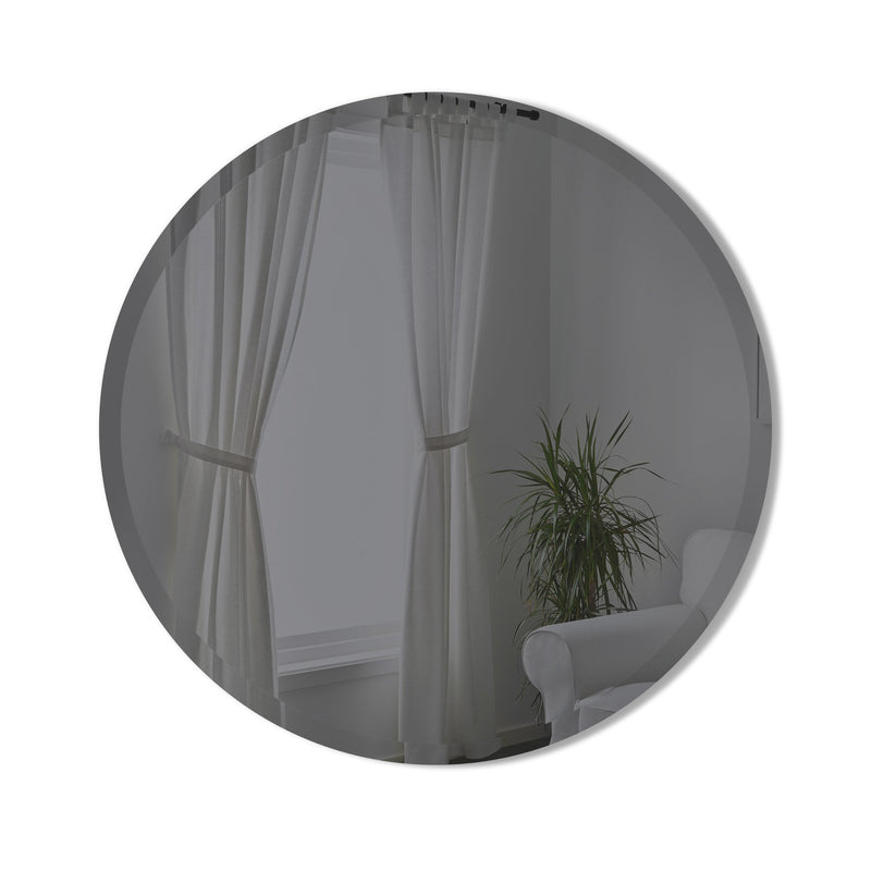 A versatile Hub Mirror - Bevy 36" - Smoke from the Umbra range enhances the charm of a room adorned with curtains and a plant.