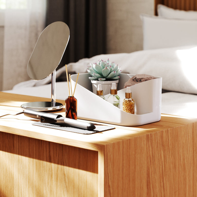 An Umbra GLAM HAIR TOOL ORGANIZER with a mirror on a bedside table.