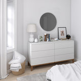 A versatile white dresser in a bedroom with an Umbra Hub Mirror - Bevy 36" - Smoke.