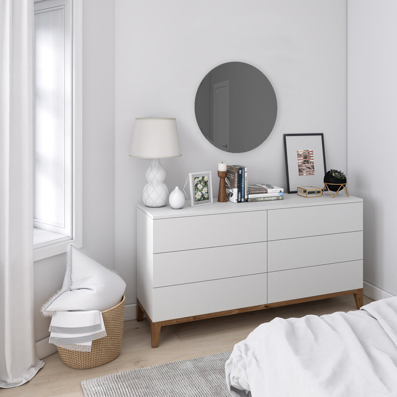 A versatile white dresser in a bedroom with an Umbra Hub Mirror - Bevy 36" - Smoke.