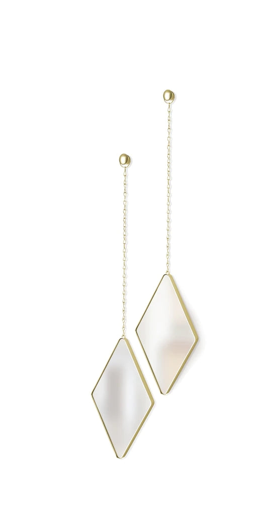 A pair of DIMA MIRROR - BRASS mirrors hanging from a chain, with argyle patterns adorning their frames. Brand: Umbra.