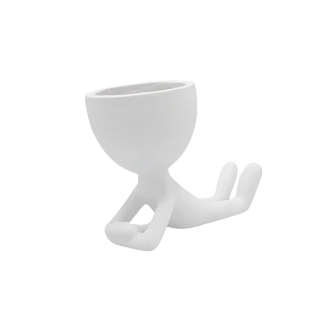 White egg head planter shaped as a seated figure, on a plain background