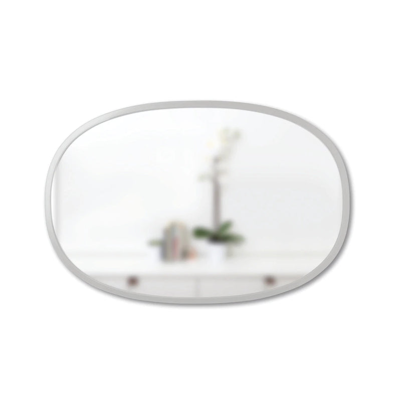 An Umbra HUB MIRROR OVAL 61 X 91 GREY with a rubber rim displayed on a white table.
