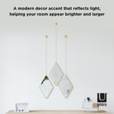Modern decor with Umbra's DIMA Mirror - Brass that reflects light, helping your room appear brighter and larger.