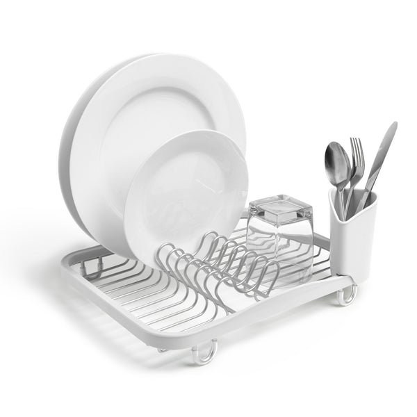 An Umbra SINKIN DISH RACK WHITE with utensils and plates on it.