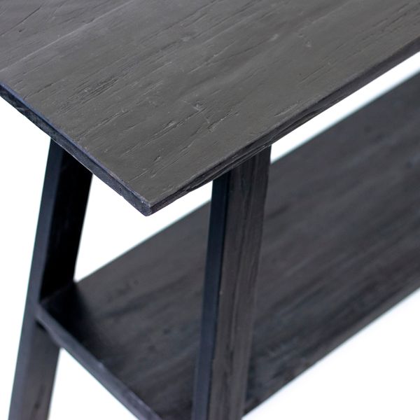 Close on the black console's plank top and the join where the leg meets the frame