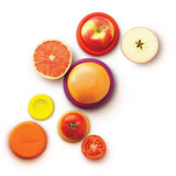 A group of oranges, grapes, apples and oranges are individually wrapped with SET OF 5 - AUTUMN HARVEST food huggers on a white surface.