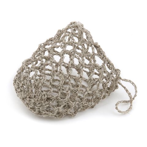 A small Scandinavian homeware Florence crocheted bag containing a 100% Hemp Soap Saver with Soap on a white surface.