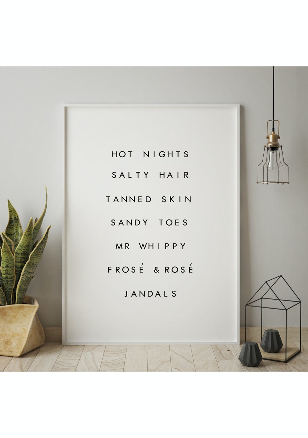 NZ Summer print in a white frame leaning on a grey wall beside a potted plant and pendant light