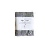 A grey cloth with the words ORGANIC FACE TOWEL on it (brand: Nawrap).