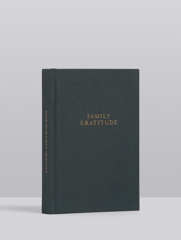A book teaching about living in gratitude, with the words "FAMILY GRATITUDE JOURNAL | STONE" by Write To Me on it.