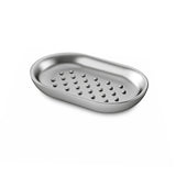 A Junip Oval Soap Dish - Stainless Steel by Umbra, with holes on it, perfect for using as a soap dish.