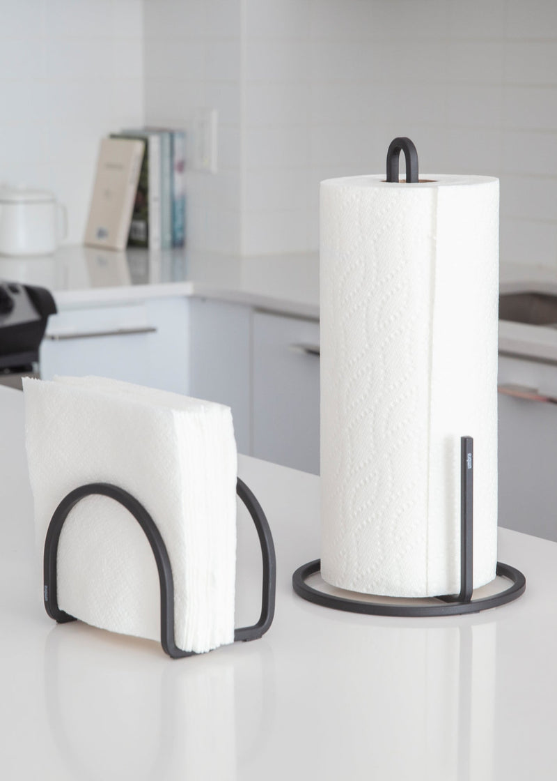 Two Umbra SQUIRE COUNTERTOP PAPER TOWEL HOLDERS on a counter top.