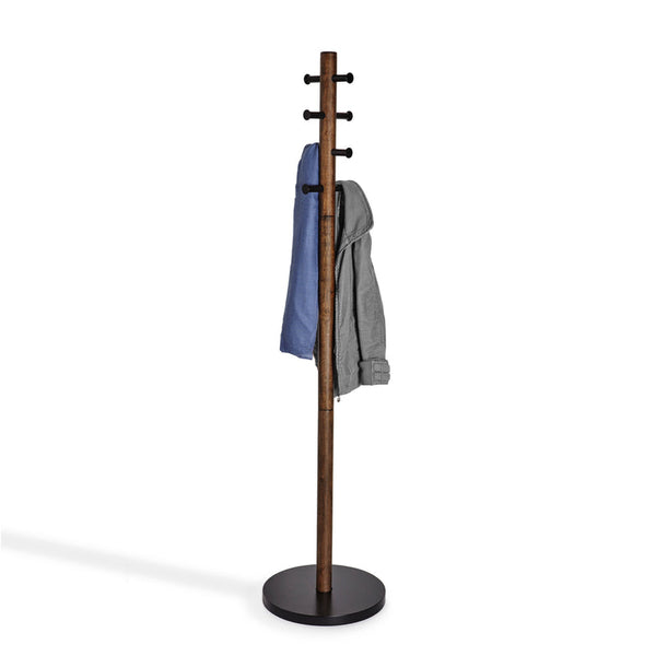 An Umbra Pillar Coat Rack providing storage with a coat hanging on it.