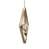 An elegant Umbra DIMA Mirror - Brass hanging gracefully from a chain.