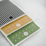 A set of ECO CLOTH - MEDIUM (3-PACK) with modern designs on them by Good Change.