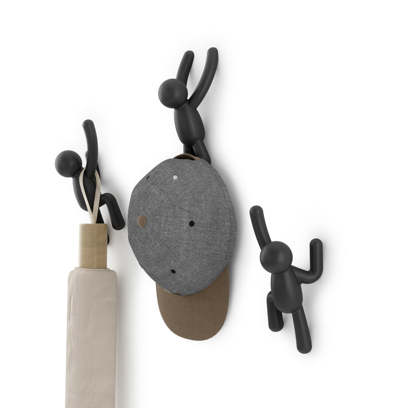 A Umbra wall décor featuring Buddy Hooks Black - Set of 3, functioning as a coat rack.