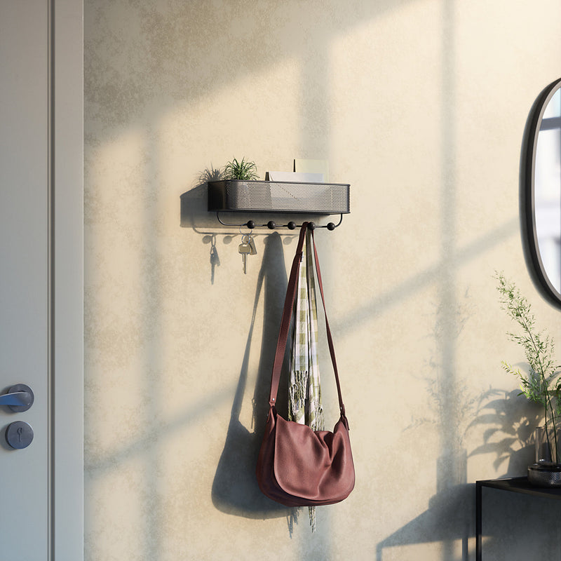 A hallway with a mirror and an Umbra ESTIQUE KEY HOOK & ORGANIZER - White / Black hanging on a hook.