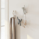 A bathroom with durable molded polypropylene Umbra Buddy Hooks - Set of 3 Multi Grey hanging on the wall.