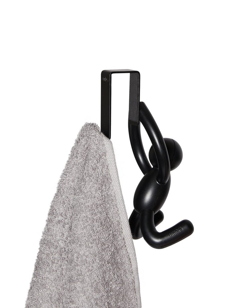 A black Umbra Buddy OTD CAB Hook towel hanger.