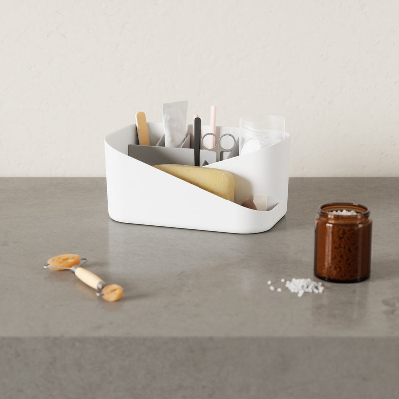 A white Umbra Glam Cosmetic Organizer with storage compartments for a toothbrush, toothpaste, and other items.