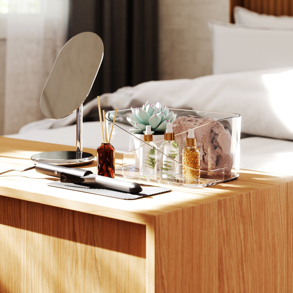 An Umbra GLAM HAIR TOOL ORGANIZER - Clear bedside table.