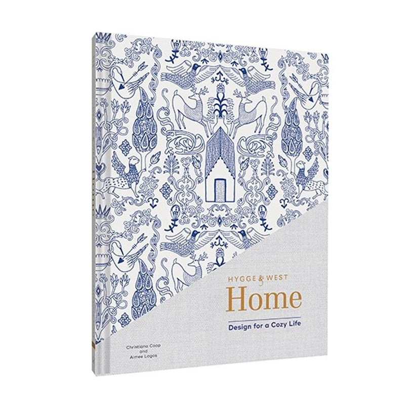 A blue and white book titled "Hygge & West Home: Design for a Cozy Life" – a perfect decoration for your personal space.