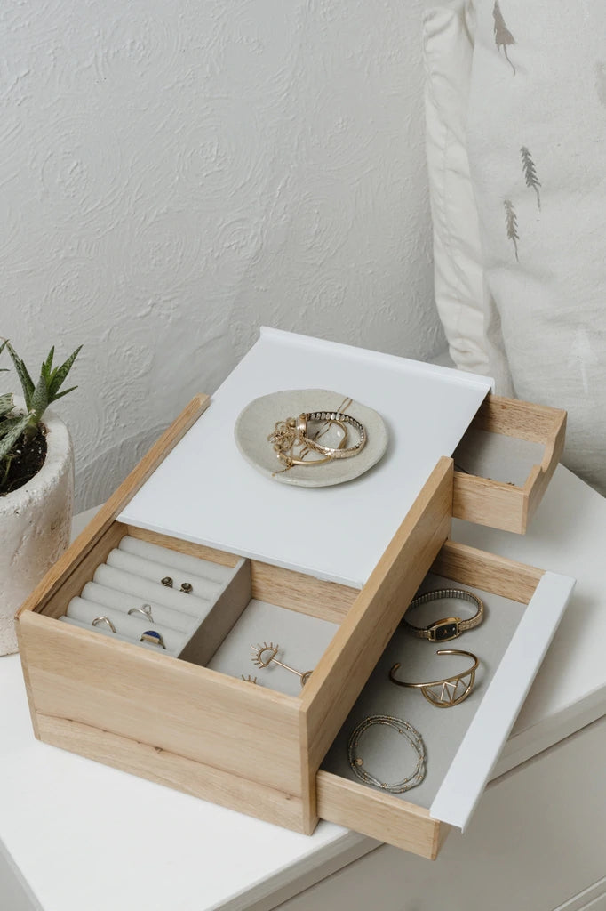 A spacious Umbra wooden jewelry box with multiple compartments for convenient storage of abundant MINI STOWIT JEWELRY BOX NATURAL/WHITE.