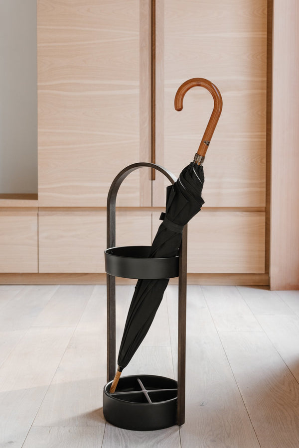 A durable Umbra HUB umbrella stand with a water-resistant resin base for compact and short umbrellas.