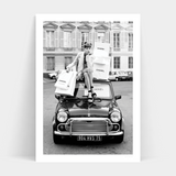 Description: A black and white photo of a woman sitting on top of a mini cooper. The RETAIL THERAPY from Art Prints is available in prints for delivery, perfect for framing.