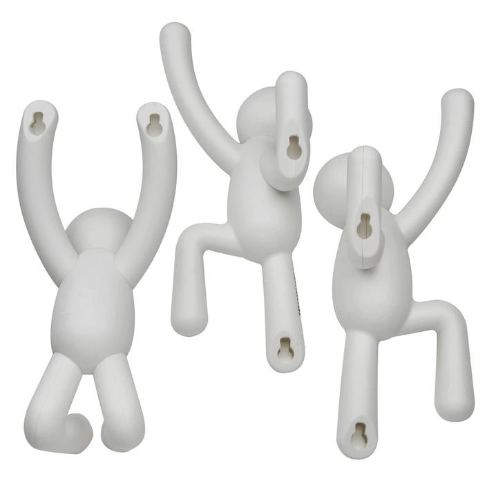 Three white plastic monkeys from the Umbra range, hanging on a durable molded polypropylene white surface using Buddy Hooks - Set of 3 Multi Grey.