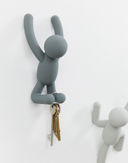 Umbra Buddy hook in grey holding a set of keys, a white Buddy hook beside it