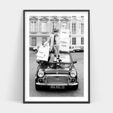 A black and white photo of a woman sitting on top of a RETAIL THERAPY mini cooper available in Art Prints.