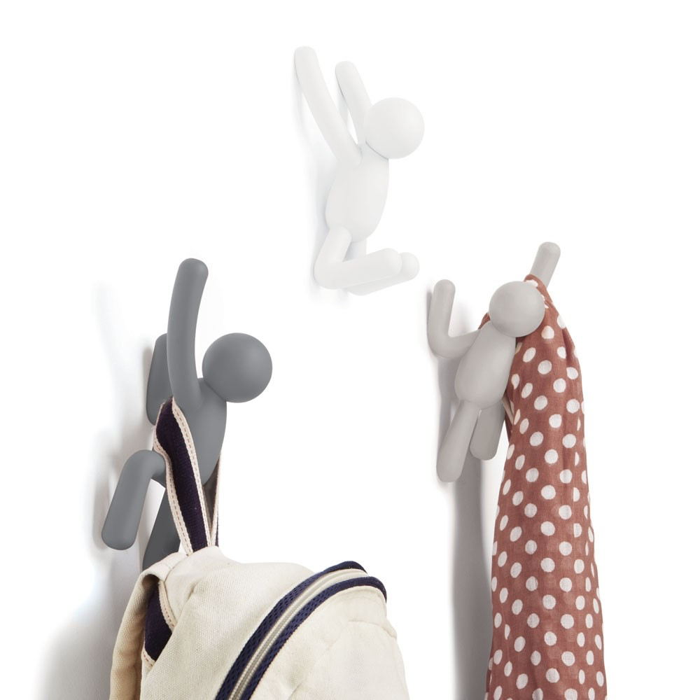 Umbra Buddy hooks in grey and white on a wall holding a bag and spotted scarf