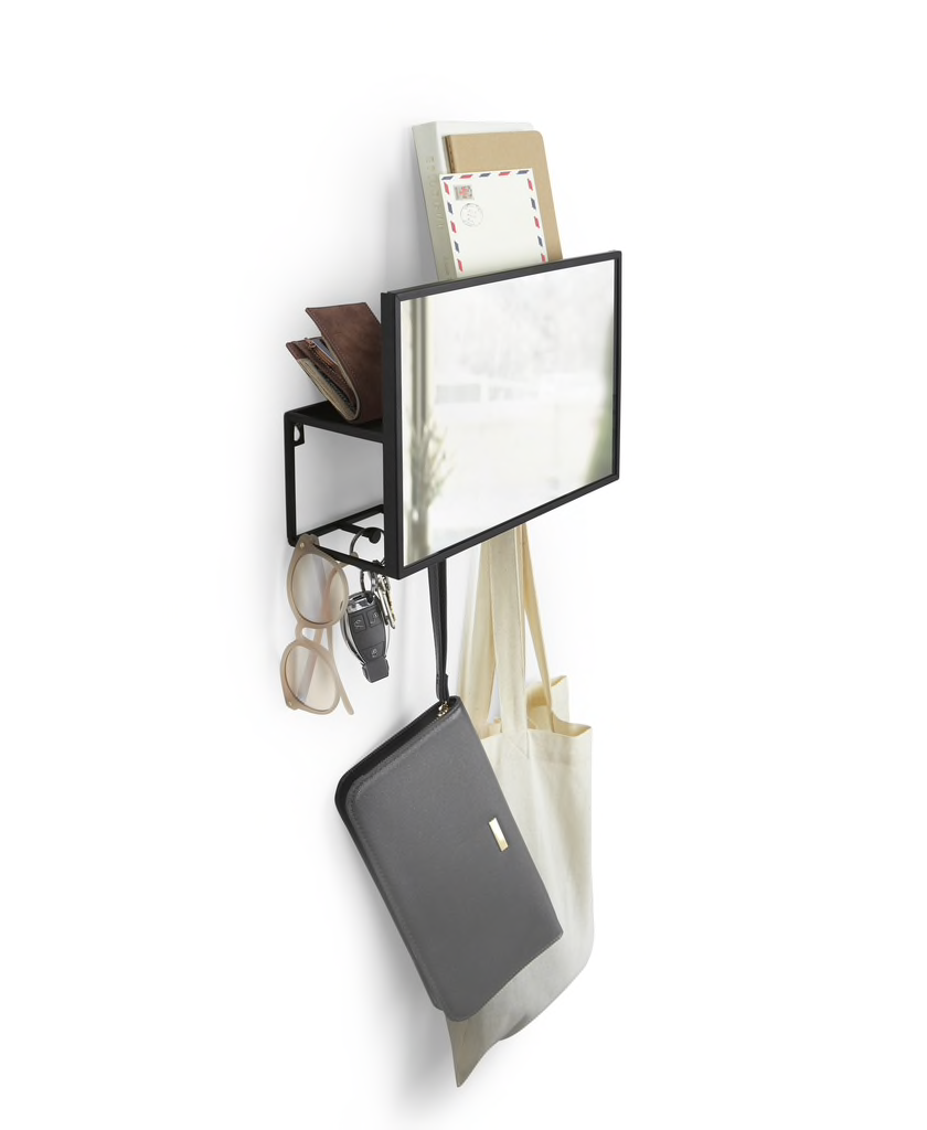 Umbra Cubiko mirror and organiser in black, wall mounted in an entryway with a bag on one hook.