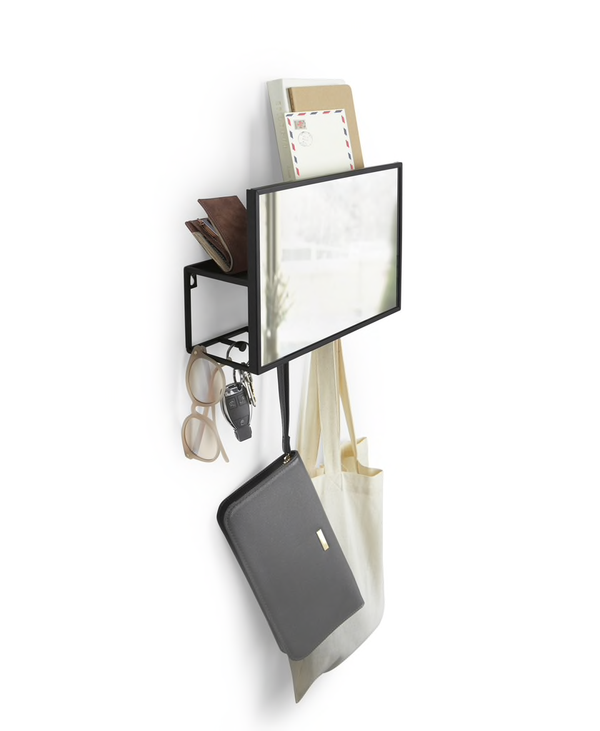 An Umbra Cubiko Mirror & Organizer - Black, the ultimate Entryway Must-Have for Small Space Living, mounted on a wall with a bag hanging on it.