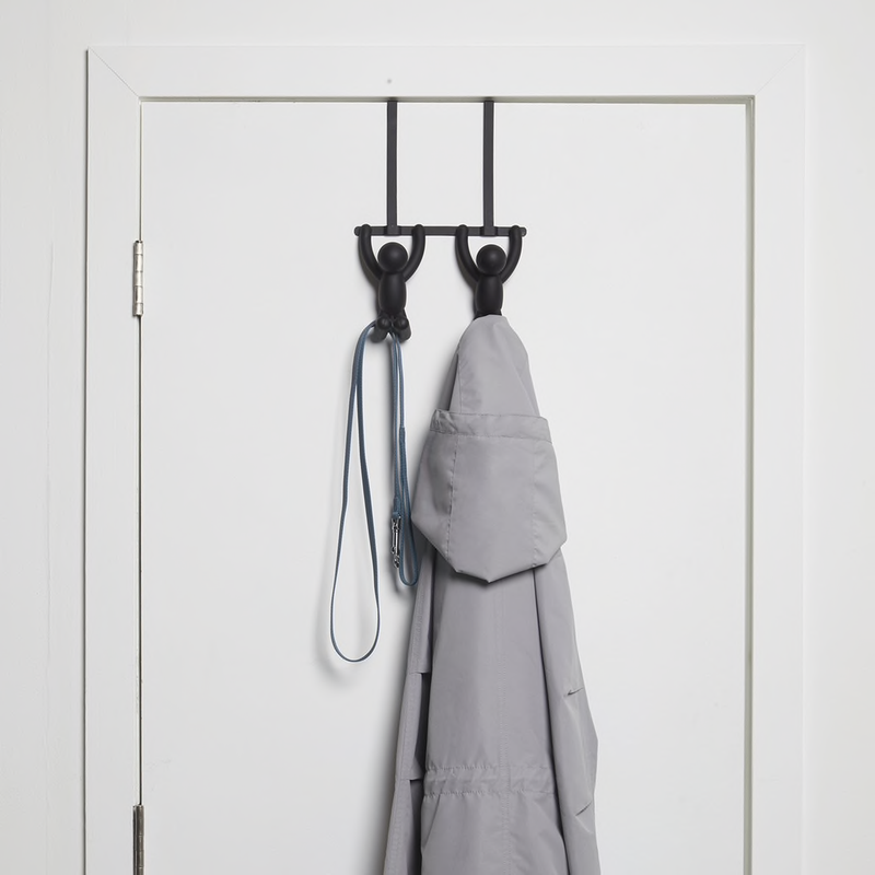 An Umbra Buddy Over-the-Door Double Hook provides a convenient and stylish solution for organizing coats on a door.