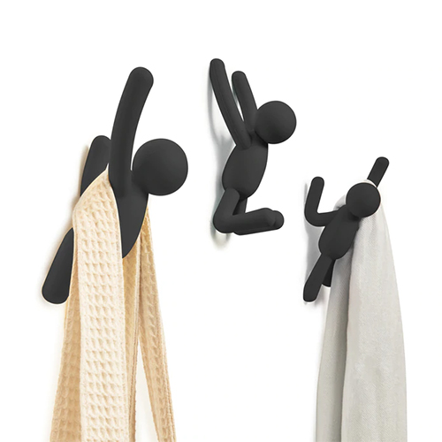 Three Umbra Buddy Hooks Black - Set of 3 serving as wall décor or a coat rack.